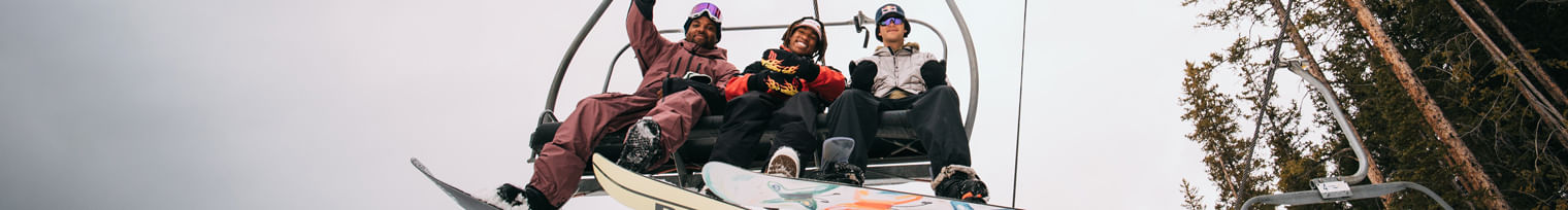 3 Snowboarders on Chair Lift