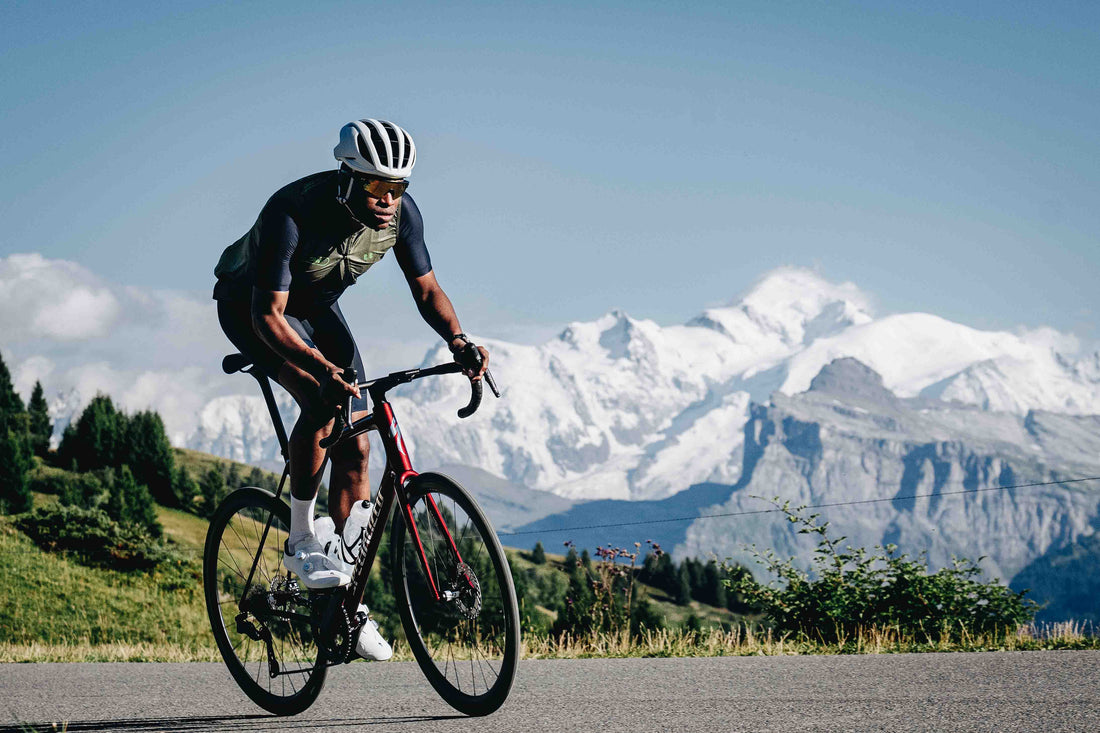 A man riding the Aethos 2 with a mountain range in the background